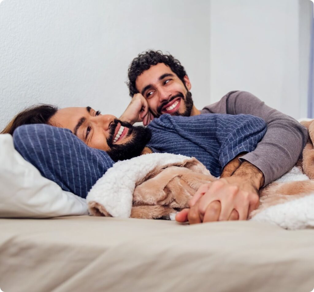 gay-male-couple-relaxing-on-bed-with-clasped-hands-2025-03-09-15-15-26-utc (1)
