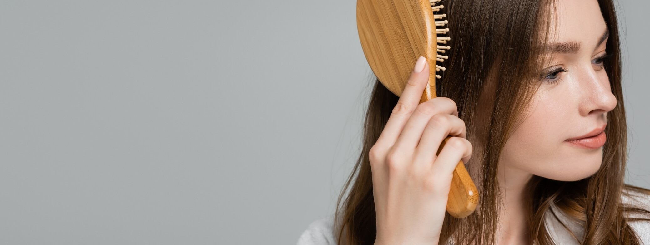 pretty-young-woman-in-bathrobe-brushing-shiny-and-2023-11-27-05-16-28-utc (1)